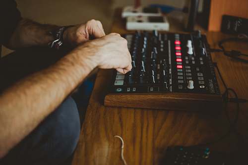 computer keyboard person playing audio interface inside well-lit room electronics
